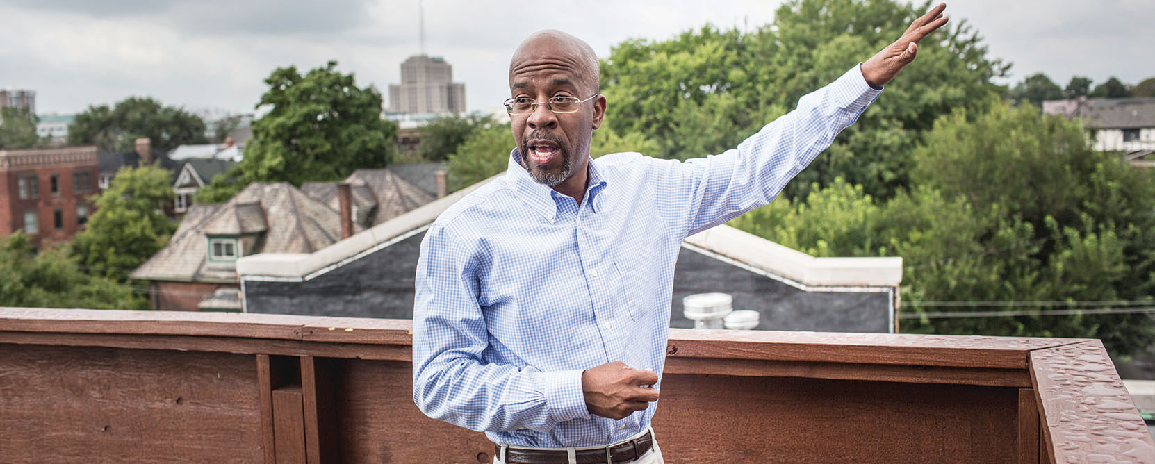 Richard Hosey poses on rooftop of building